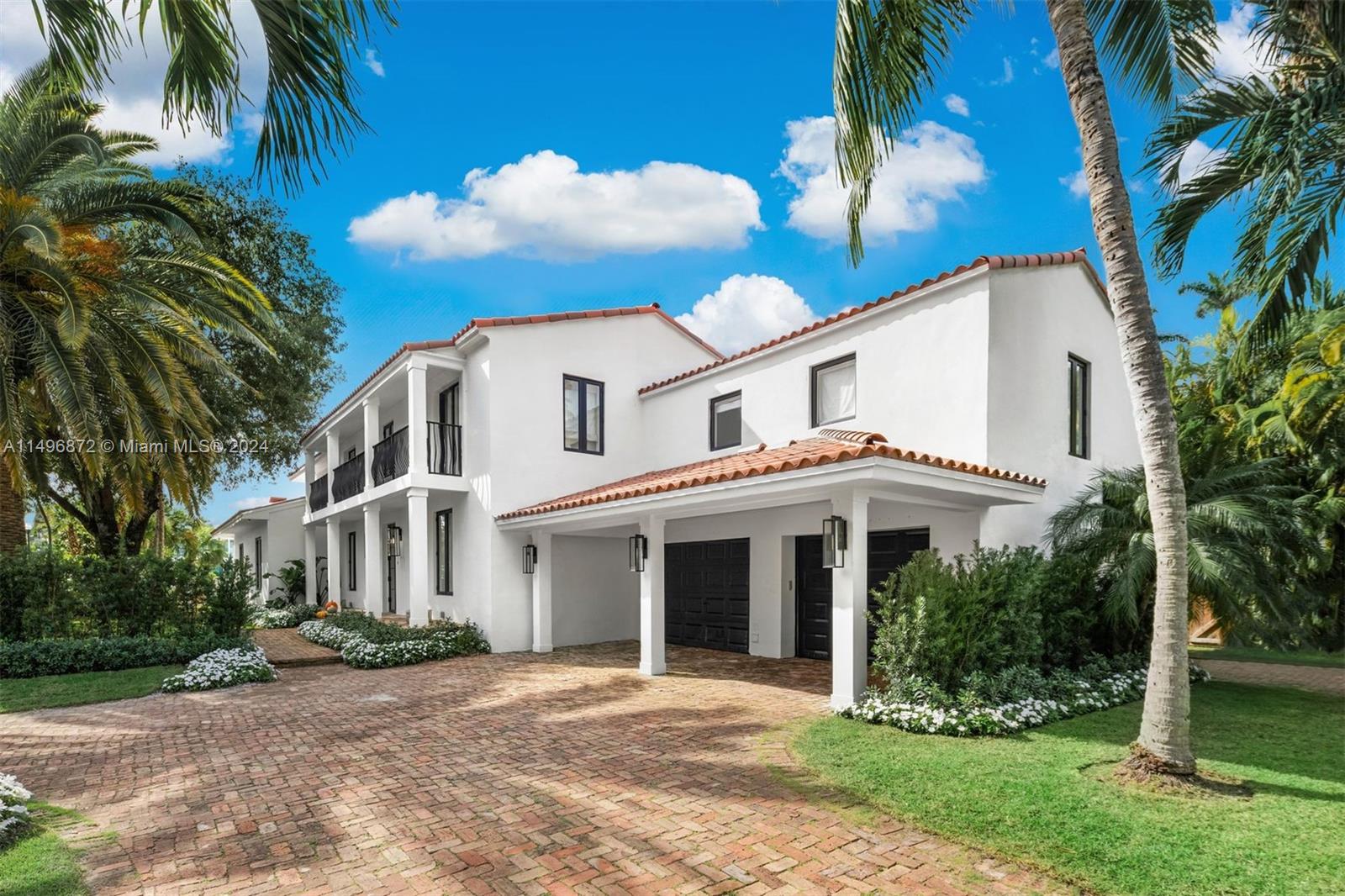 2770 Sunset Drive Miami Beach, FL 33140 - Photo 49 of 56 a front view of a house with a garden