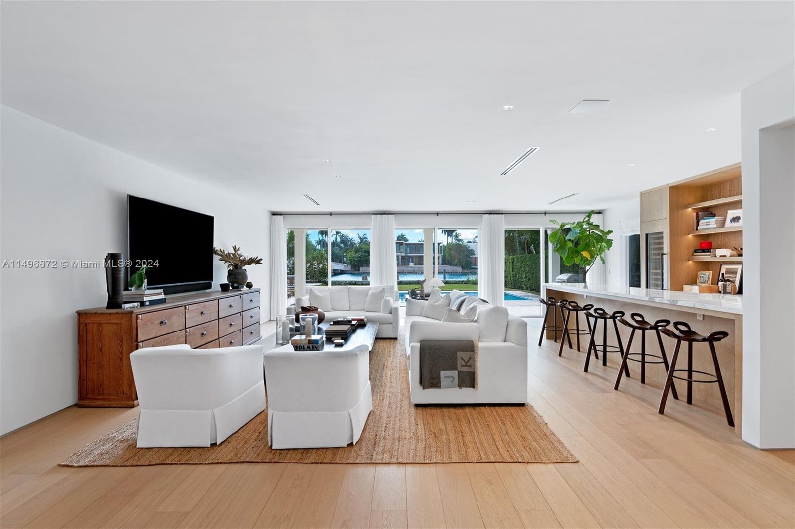 2770 Sunset Drive Miami Beach, FL 33140 - Photo 9 of 56 a living room with furniture a flat screen tv and a fireplace
