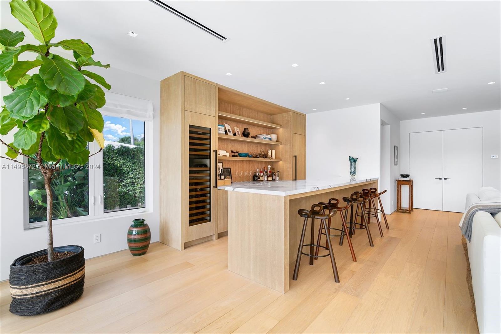 2770 Sunset Drive Miami Beach, FL 33140 - Photo 10 of 56 a view of a dining room with furniture and a potted plant