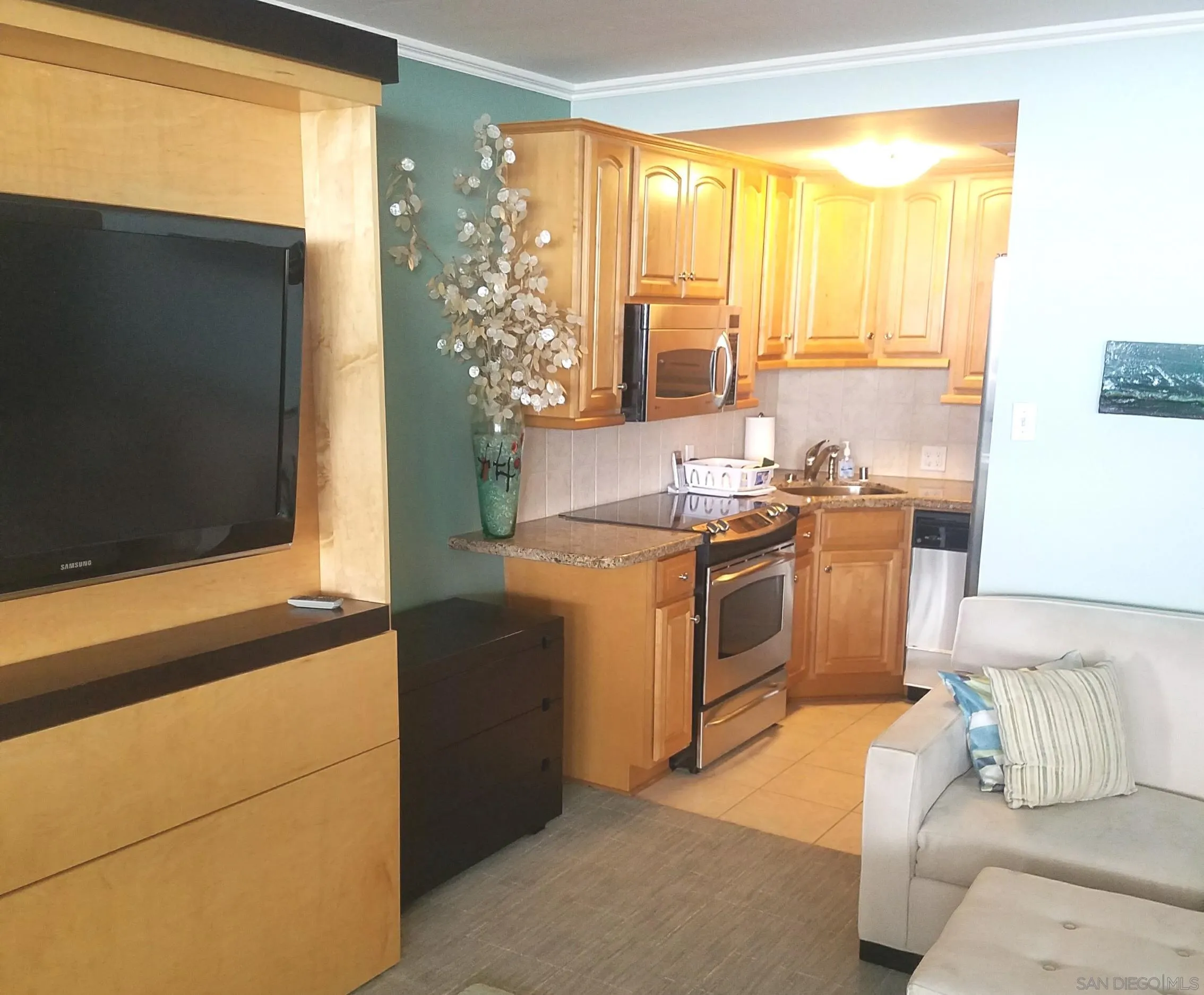 939 Coast Boulevard, Unit 3D La Jolla, CA 92037 - Photo 5 of 13 a kitchen with stainless steel appliances a stove a sink and a refrigerator