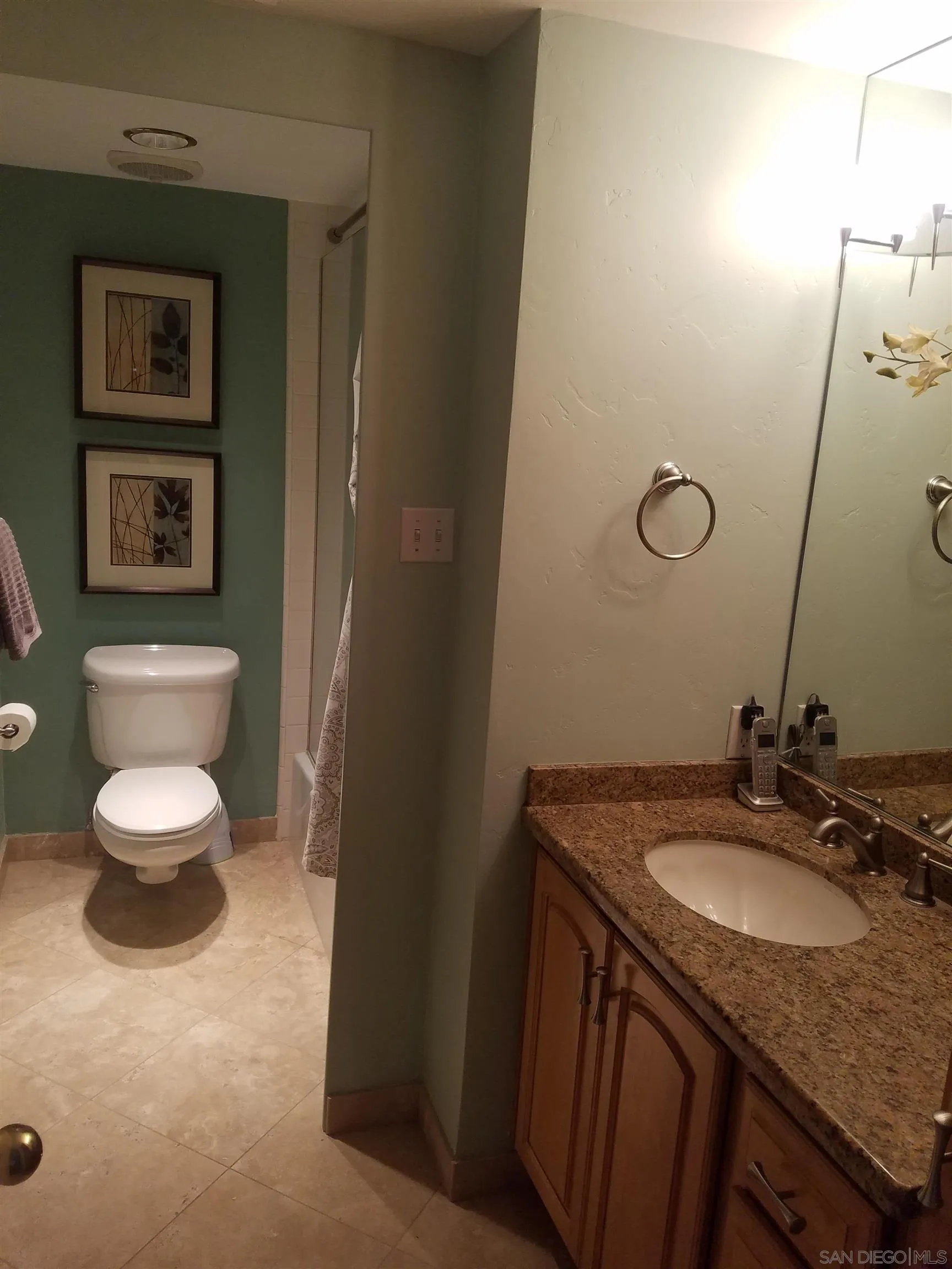 939 Coast Boulevard, Unit 3D La Jolla, CA 92037 - Photo 7 of 13 a bathroom with a granite countertop sink toilet and a mirror