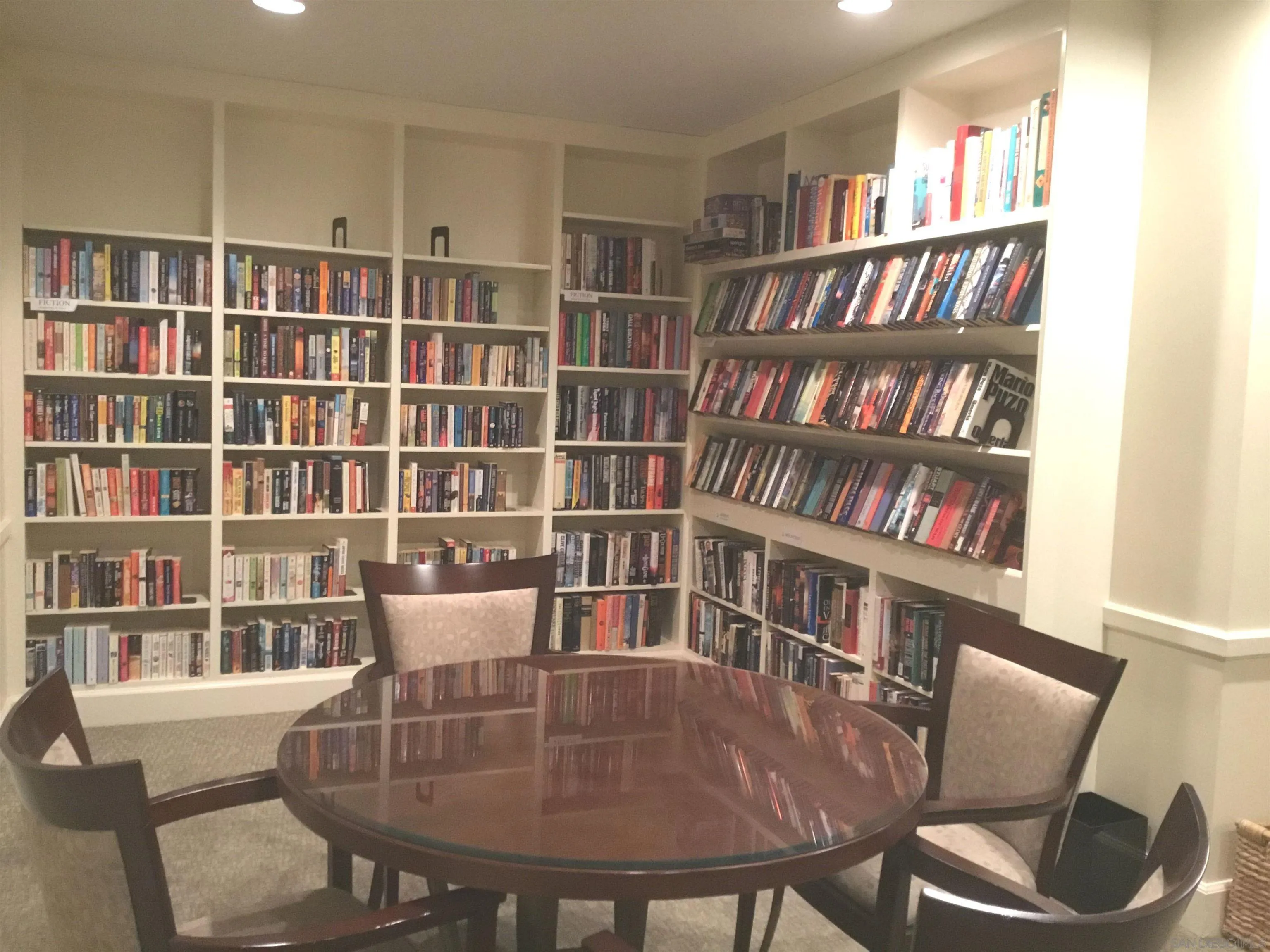 939 Coast Boulevard, Unit 3D La Jolla, CA 92037 - Photo 9 of 13 a view of a dining room with furniture and a book shelf