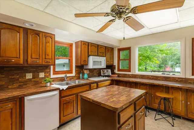 a kitchen with stainless steel appliances granite countertop a refrigerator and a stove top oven