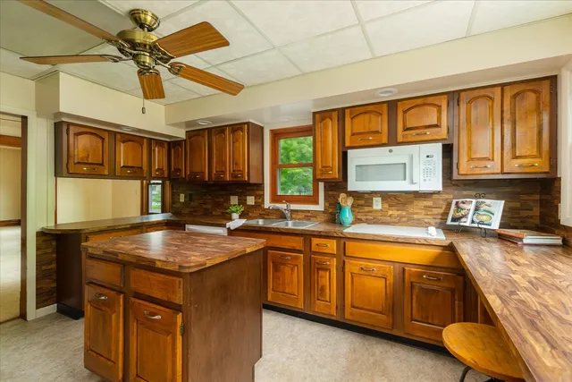 a view of a hallway with wooden floor and stairs
