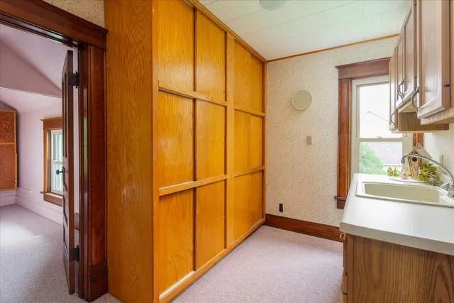 a view of a room with a window and a ceiling fan
