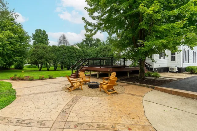 a view of a backyard with sitting area