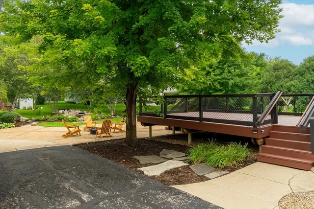 a view of a wooden deck and backyard
