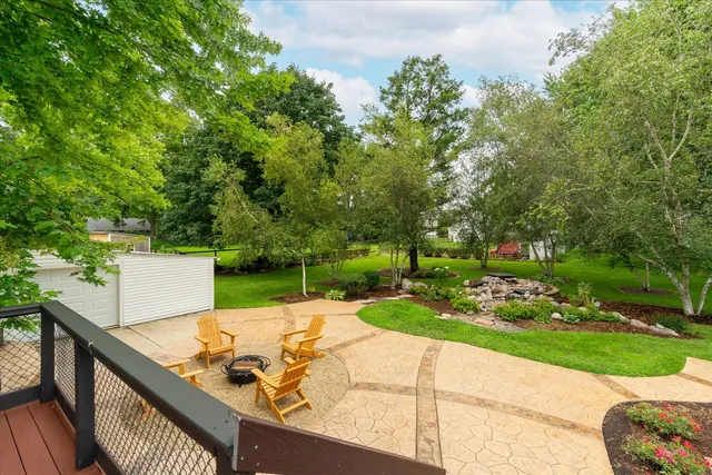 a view of a patio with table and chairs under an umbrella