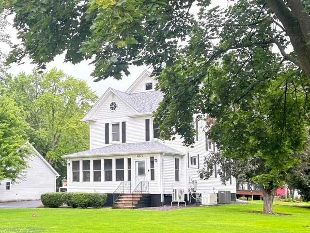 a front view of a house with a garden