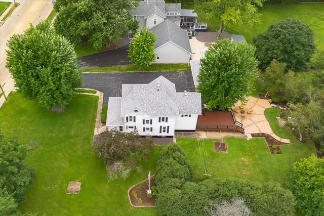 an aerial view of a house with swimming pool and garden