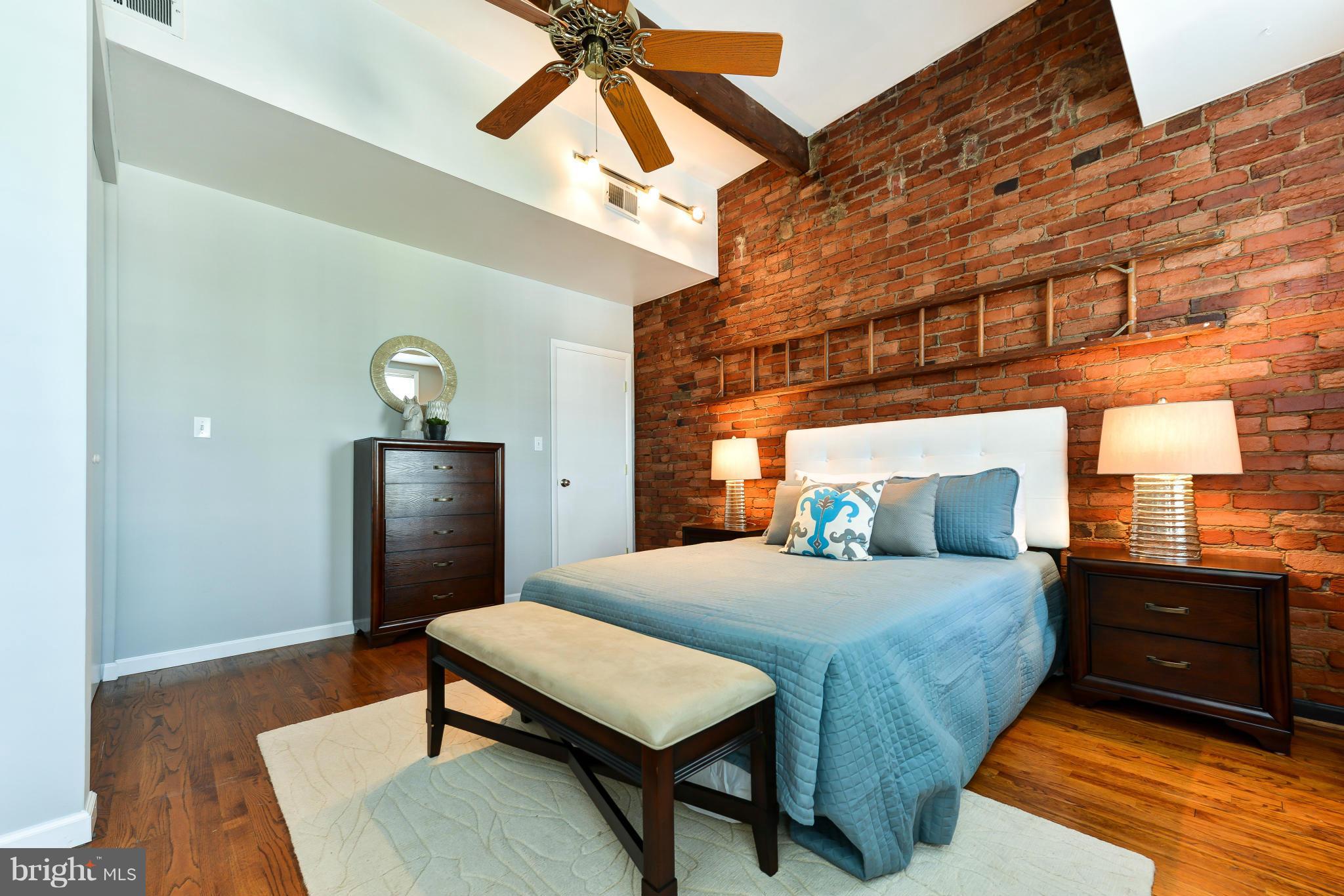 1243 Linden Place Northeast Washington, DC 20002 - Photo 17 of 30 a bedroom with a bed and a chandelier