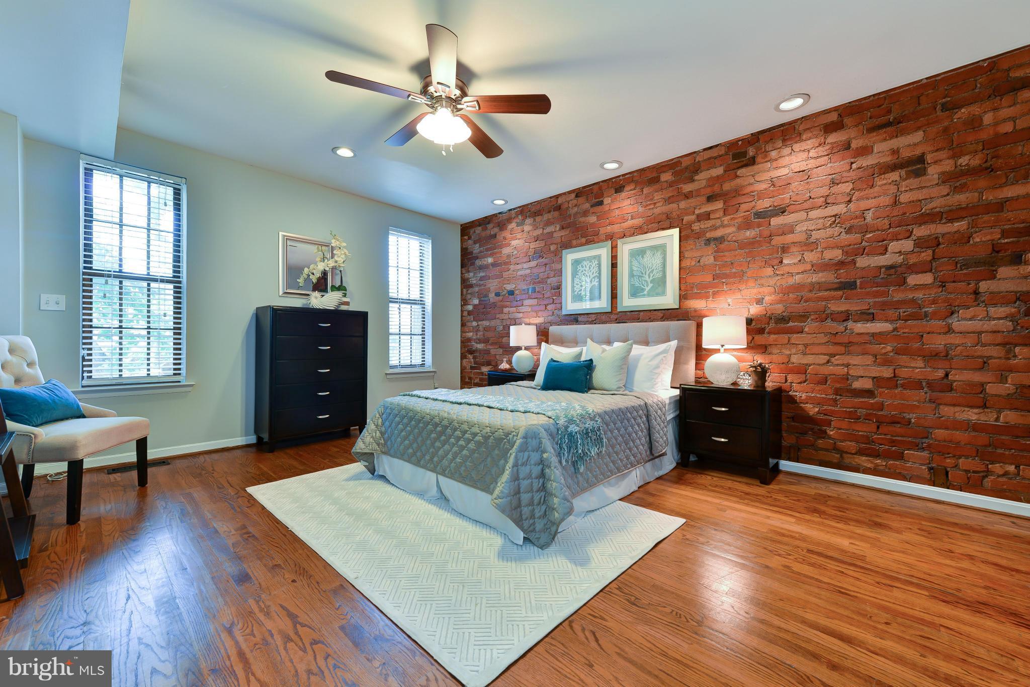 1243 Linden Place Northeast Washington, DC 20002 - Photo 20 of 30 a spacious bedroom with a bed and wooden floor
