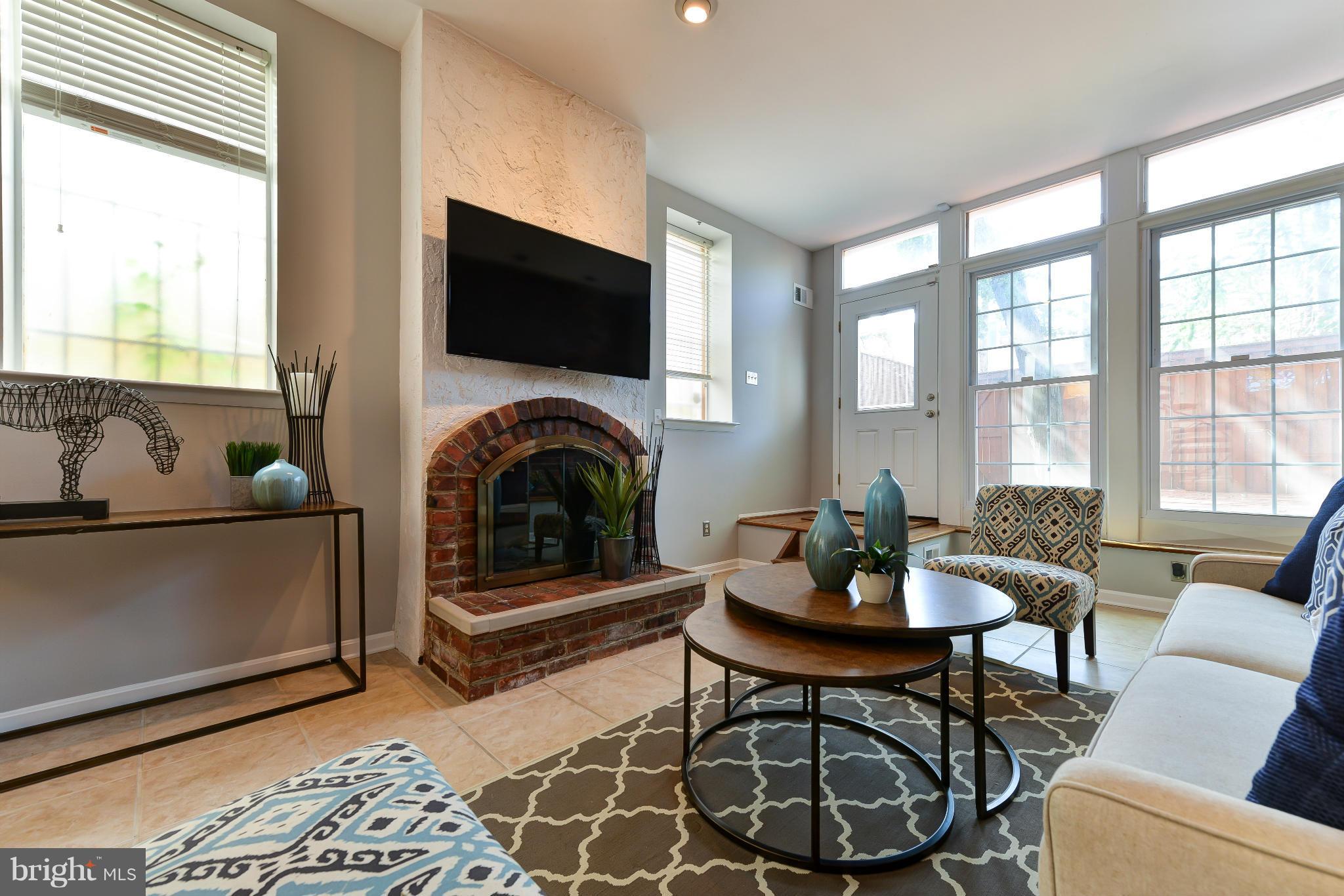 1243 Linden Place Northeast Washington, DC 20002 - Photo 4 of 30 a living room with furniture a flat screen tv and a fireplace