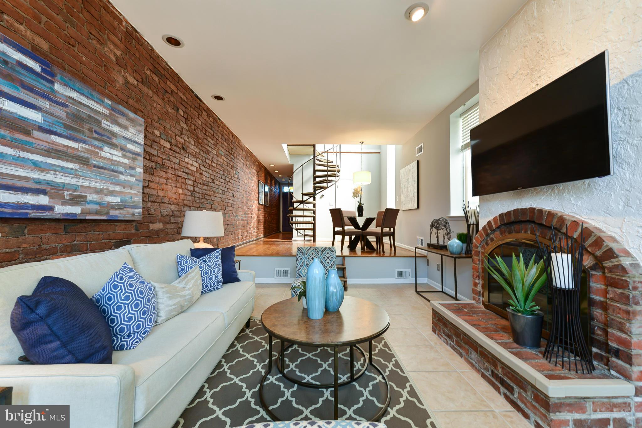 1243 Linden Place Northeast Washington, DC 20002 - Photo 6 of 30 a living room with furniture a flat screen tv and a fireplace