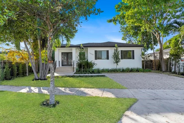 a front view of house with yard and green space