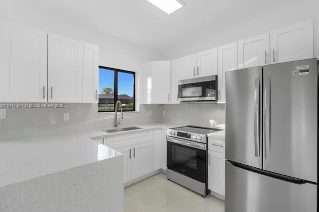 a kitchen with a sink stove and refrigerator