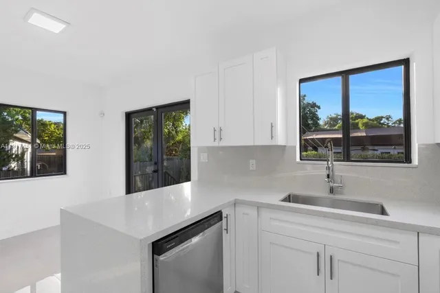 a kitchen with a sink and large window