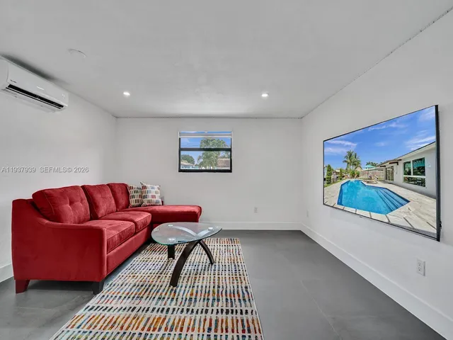 a living room with furniture and a rug