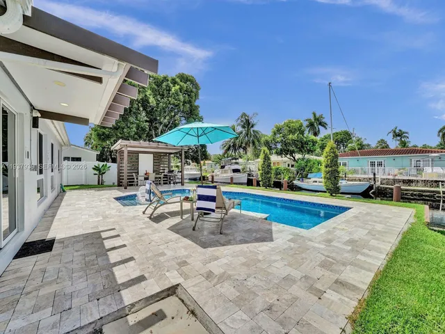 a view of a backyard with sitting area