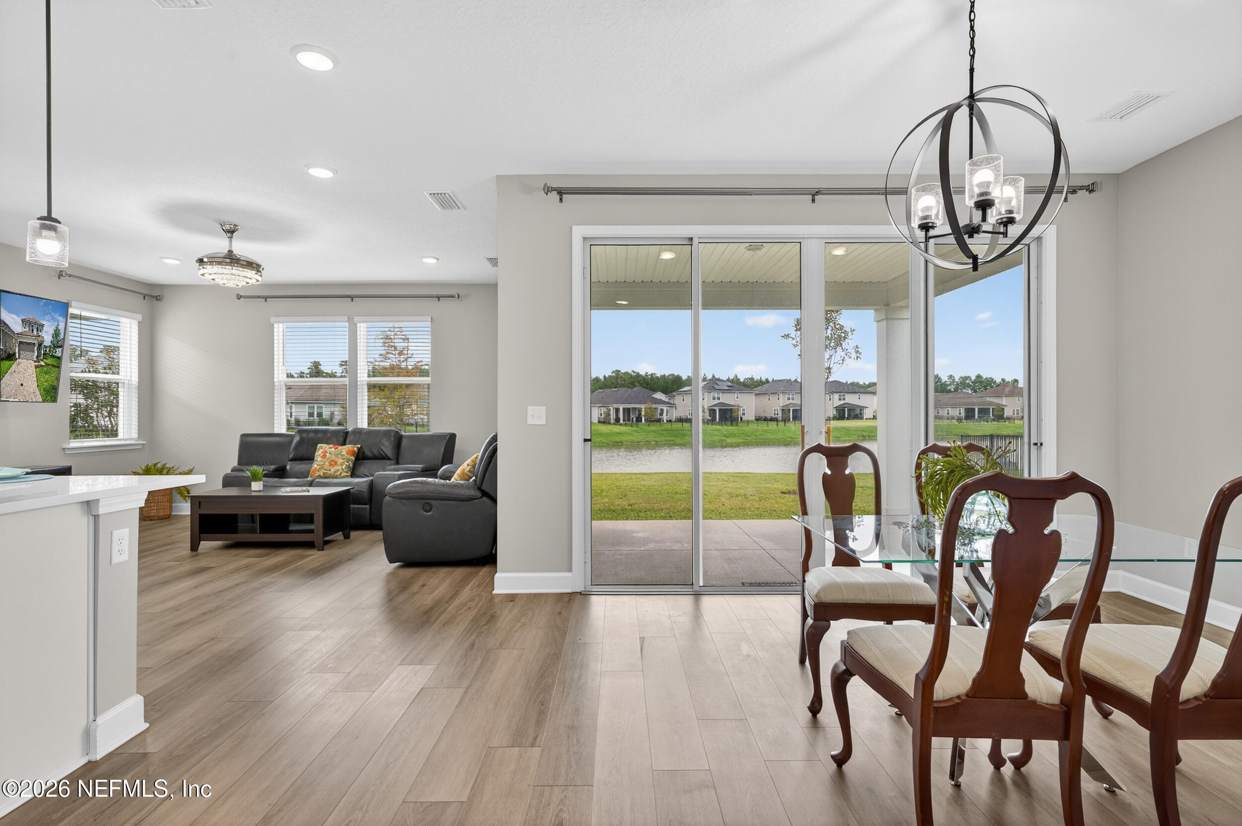 57 Cedar Elm Way St. Augustine, FL 32092 - Photo 9 of 65 a living room with furniture floor to ceiling windows and a floor to ceiling window