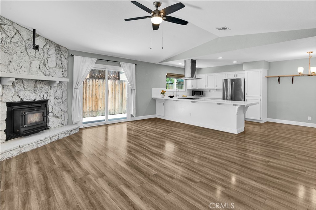 2622 Pinto Lane Paso Robles, CA 93446 - Photo 22 of 22 a large white kitchen with wooden floors and fireplace