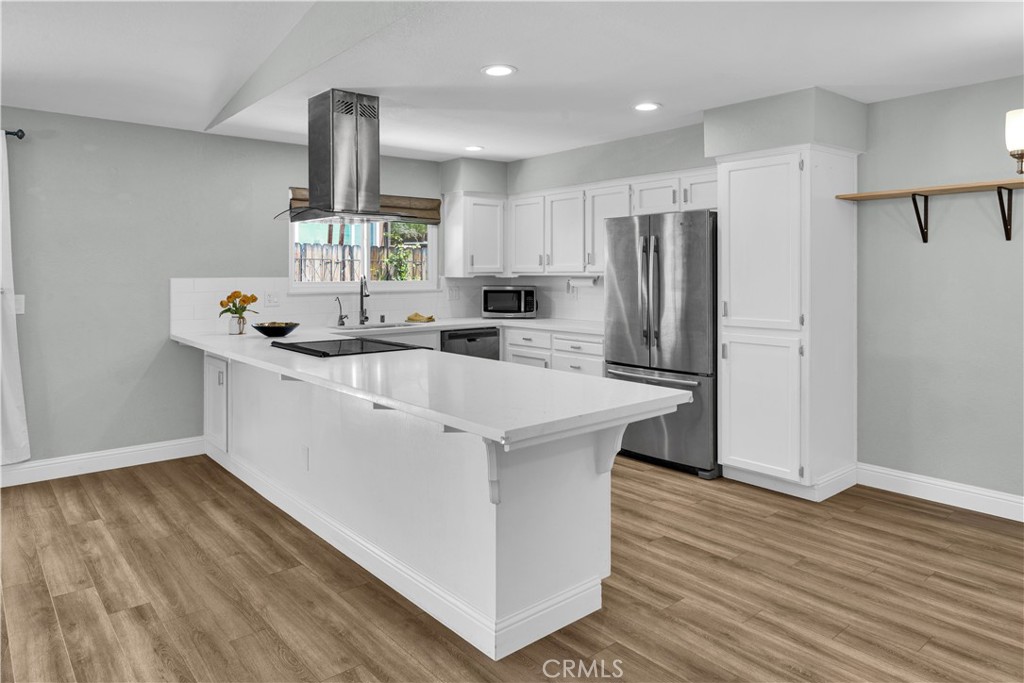 2622 Pinto Lane Paso Robles, CA 93446 - Photo 7 of 22 a kitchen with stainless steel appliances a sink a refrigerator and wooden floor