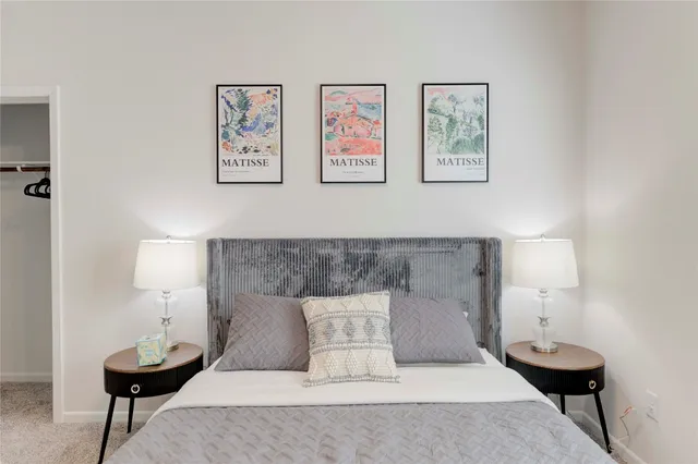 a bed room with a bed and a lamp