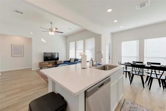 a view of kitchen with cabinets table and chairs