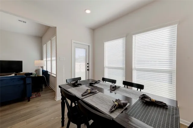 a view of a workspace with furniture and a flat screen tv