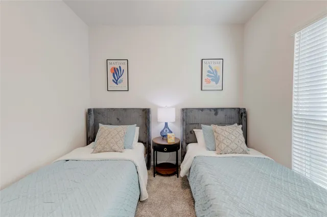 a bedroom with a bed and wall painting