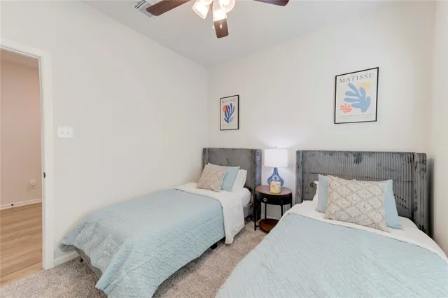 a bedroom with bed and a chandelier