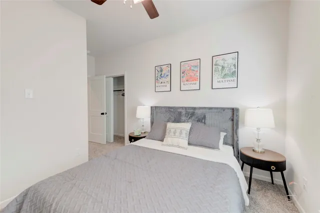 a bedroom with a bed and a lamp on table