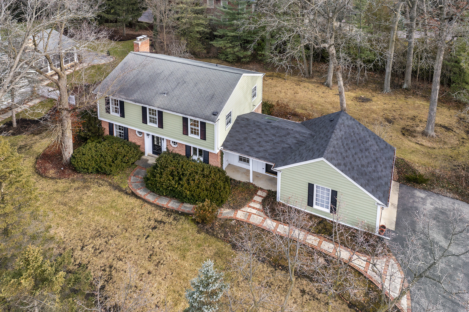 a aerial view of a house with yard and garage