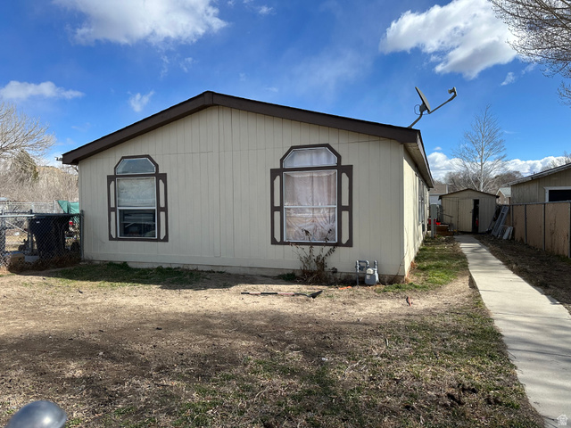 2180 North 1950th Street West Helper, UT 84526 - Photo 2 of 11 View of side of property featuring a storage unit