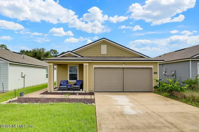 a front view of a house with a yard and garage