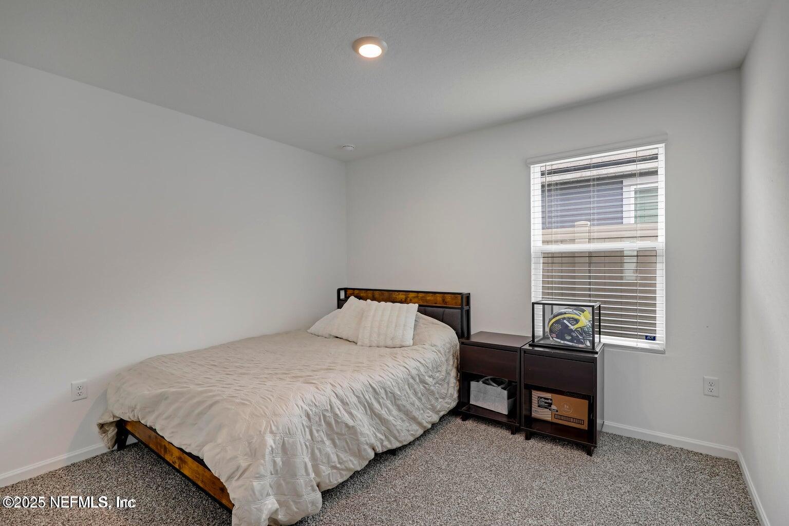 12633 Cacao Tree Trail Jacksonville, FL 32218 - Photo 11 of 44 a bedroom with a bed and a window