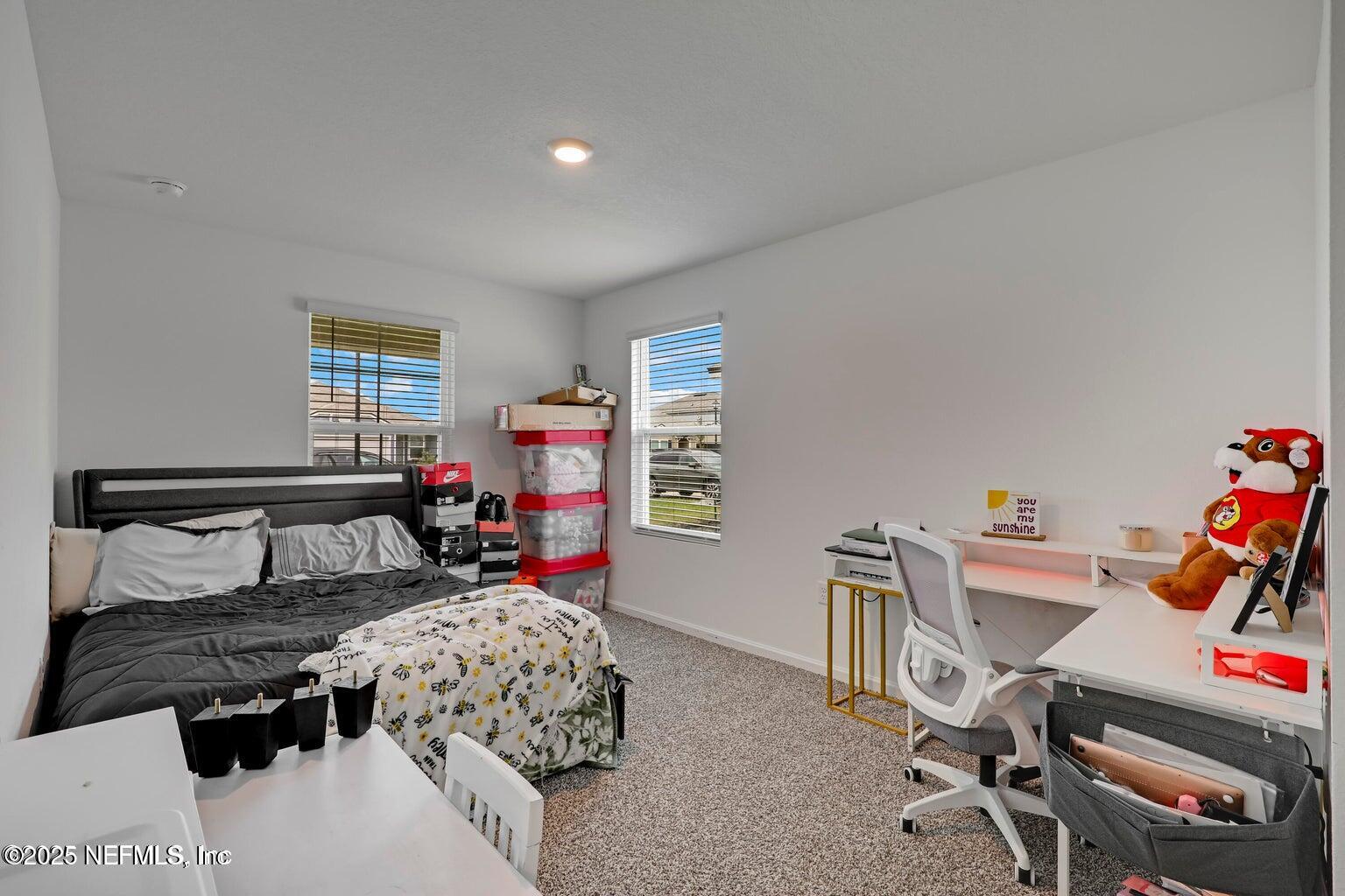 12633 Cacao Tree Trail Jacksonville, FL 32218 - Photo 14 of 44 a bedroom with furniture and a window