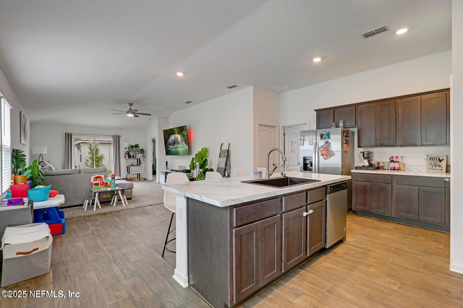 12633 Cacao Tree Trail Jacksonville, FL 32218 - Photo 16 of 44 a kitchen with stainless steel appliances granite countertop a sink dishwasher stove and wooden cabinets