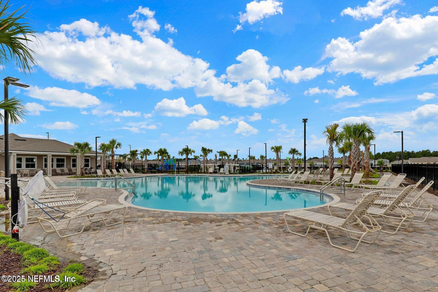 12633 Cacao Tree Trail Jacksonville, FL 32218 - Photo 37 of 44 a view of a lake with a table and chairs