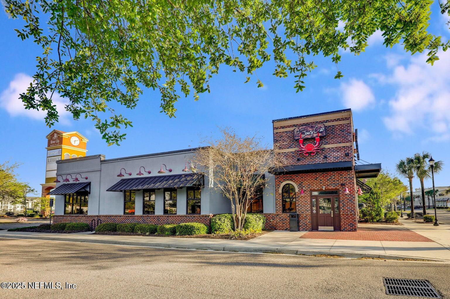 12633 Cacao Tree Trail Jacksonville, FL 32218 - Photo 43 of 44 a front view of multi story residential apartment building with yard