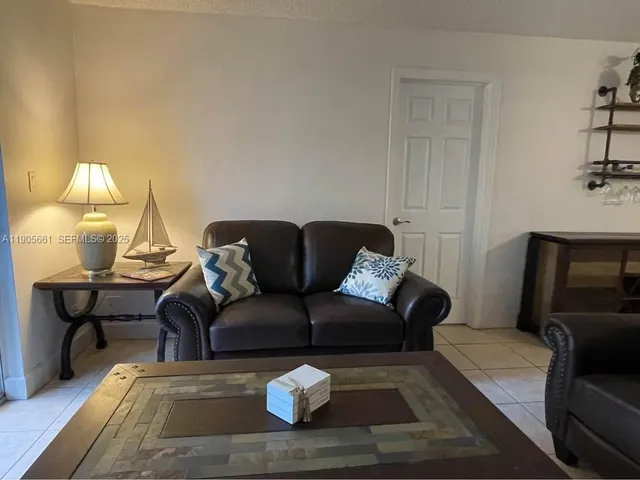 a living room with furniture and a lamp