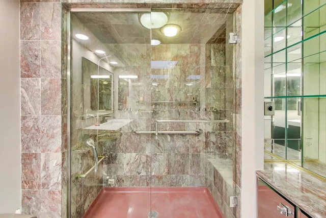 a bathroom with a tub a sink and shower