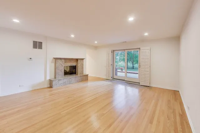 a view of room and hall with wooden floor