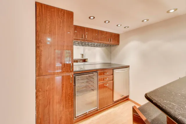 a kitchen with granite countertop a sink and a stove