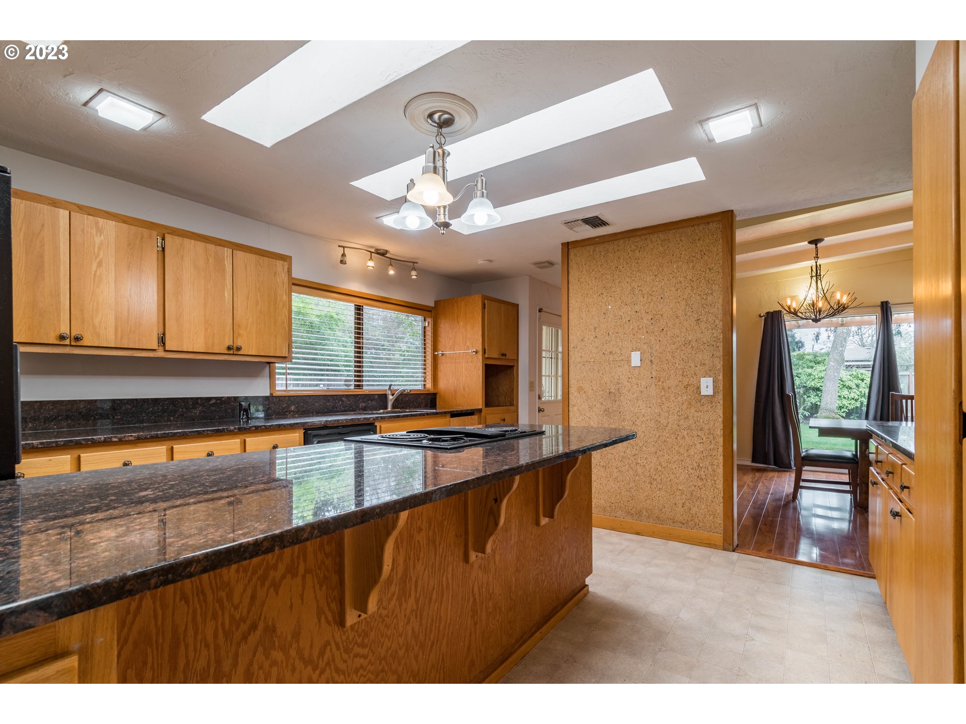 2210 Sandy Drive Eugene, OR 97401 - Photo 11 of 32 a kitchen with stainless steel appliances granite countertop a sink dishwasher a stove and a refrigerator with wooden floor