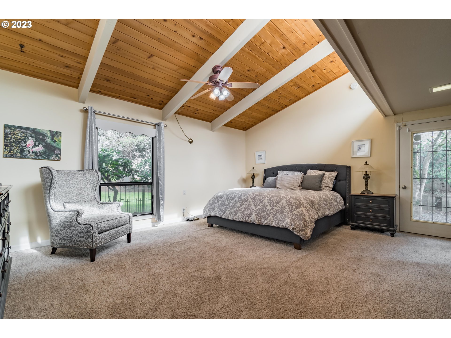 2210 Sandy Drive Eugene, OR 97401 - Photo 13 of 32 a bedroom with a bed a couch and large window