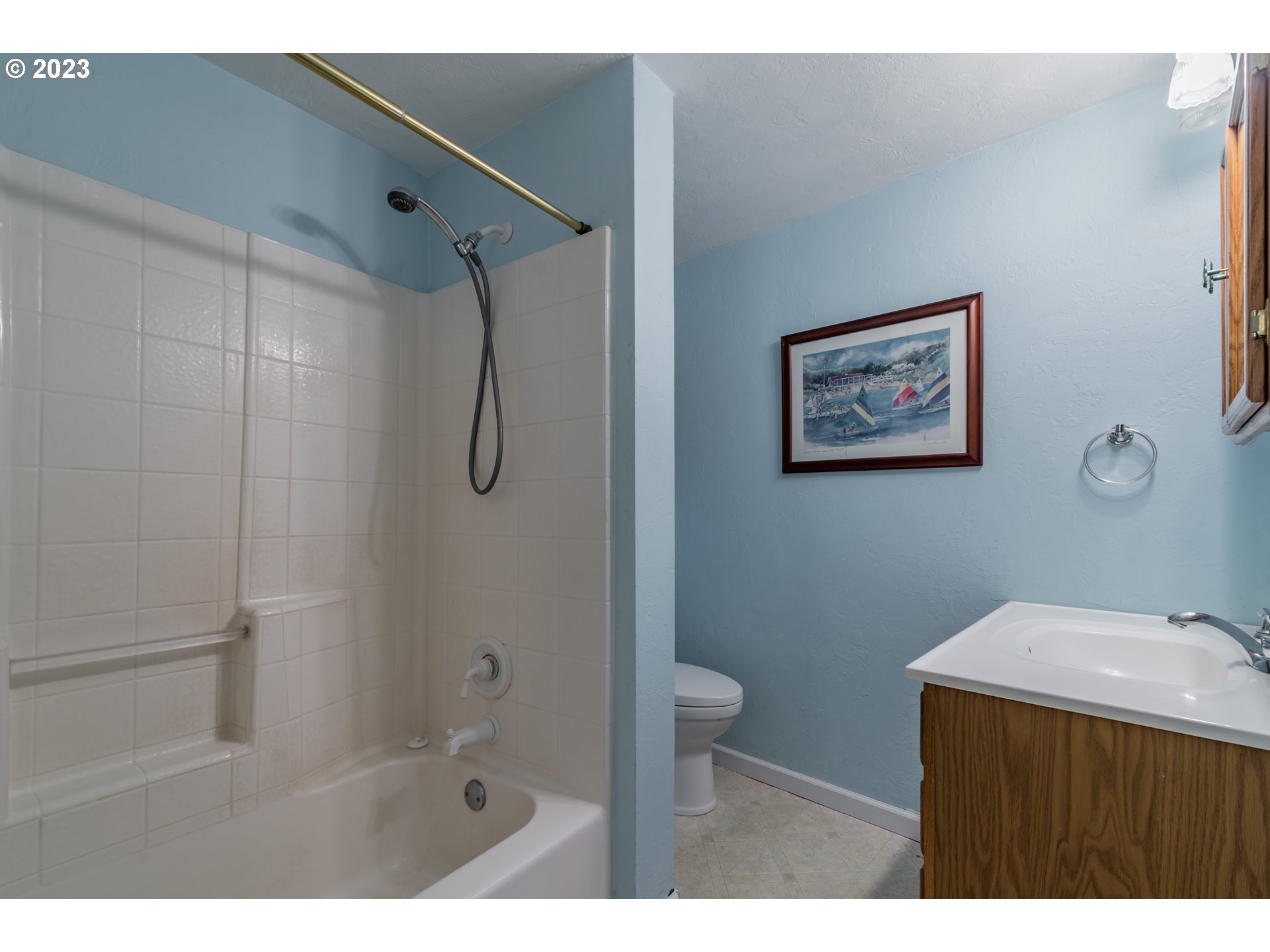 2210 Sandy Drive Eugene, OR 97401 - Photo 24 of 32 a bathroom with a granite countertop sink a mirror a toilet and shower