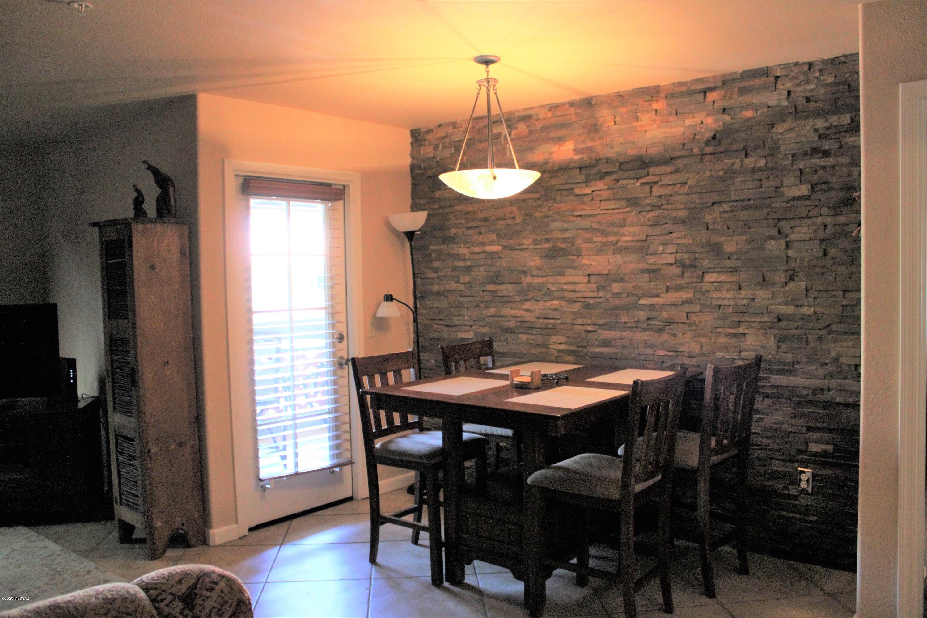 5751 North Kolb Road, Unit 36203 Tucson, AZ 85750 - Photo 8 of 25 a view of a dining room with furniture and wooden floor