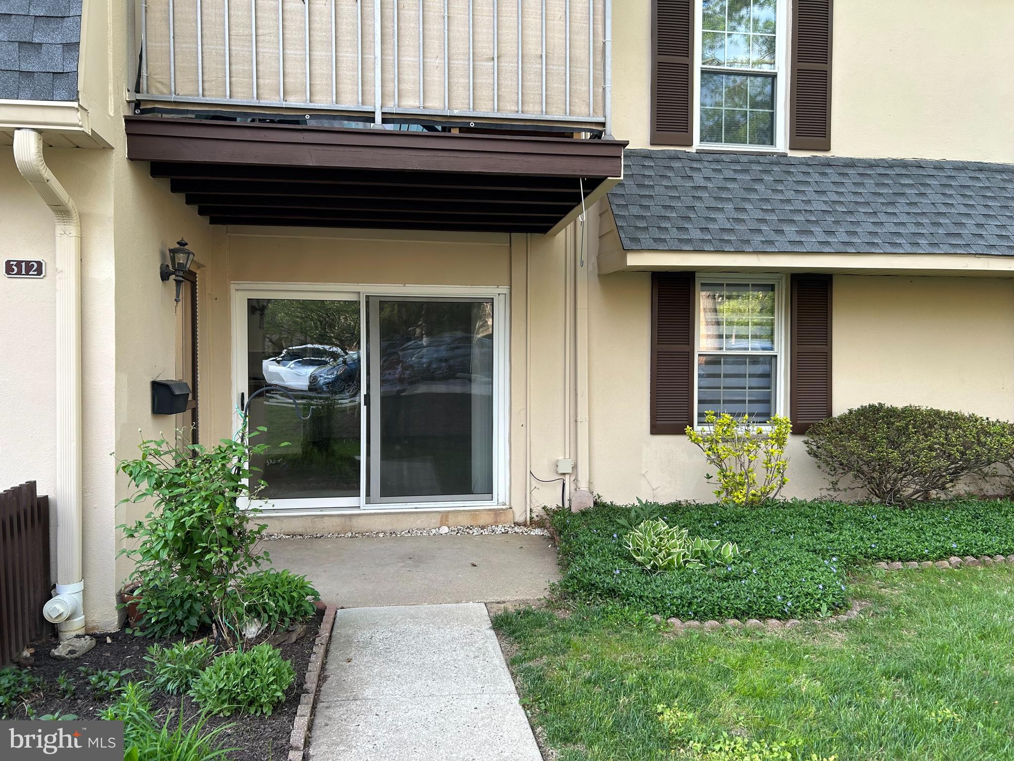 312 Old Forge Crossing, Unit 312 Devon, PA 19333 - Photo 1 of 21 a view of brick house with a large window and plants