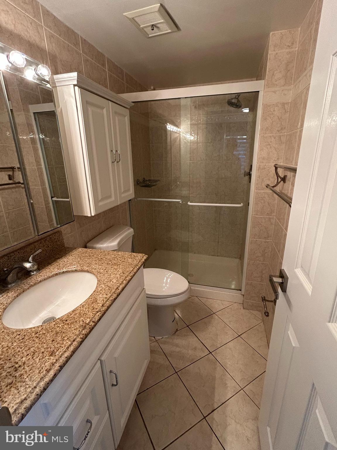 312 Old Forge Crossing, Unit 312 Devon, PA 19333 - Photo 14 of 21 a bathroom with a granite countertop sink toilet and shower